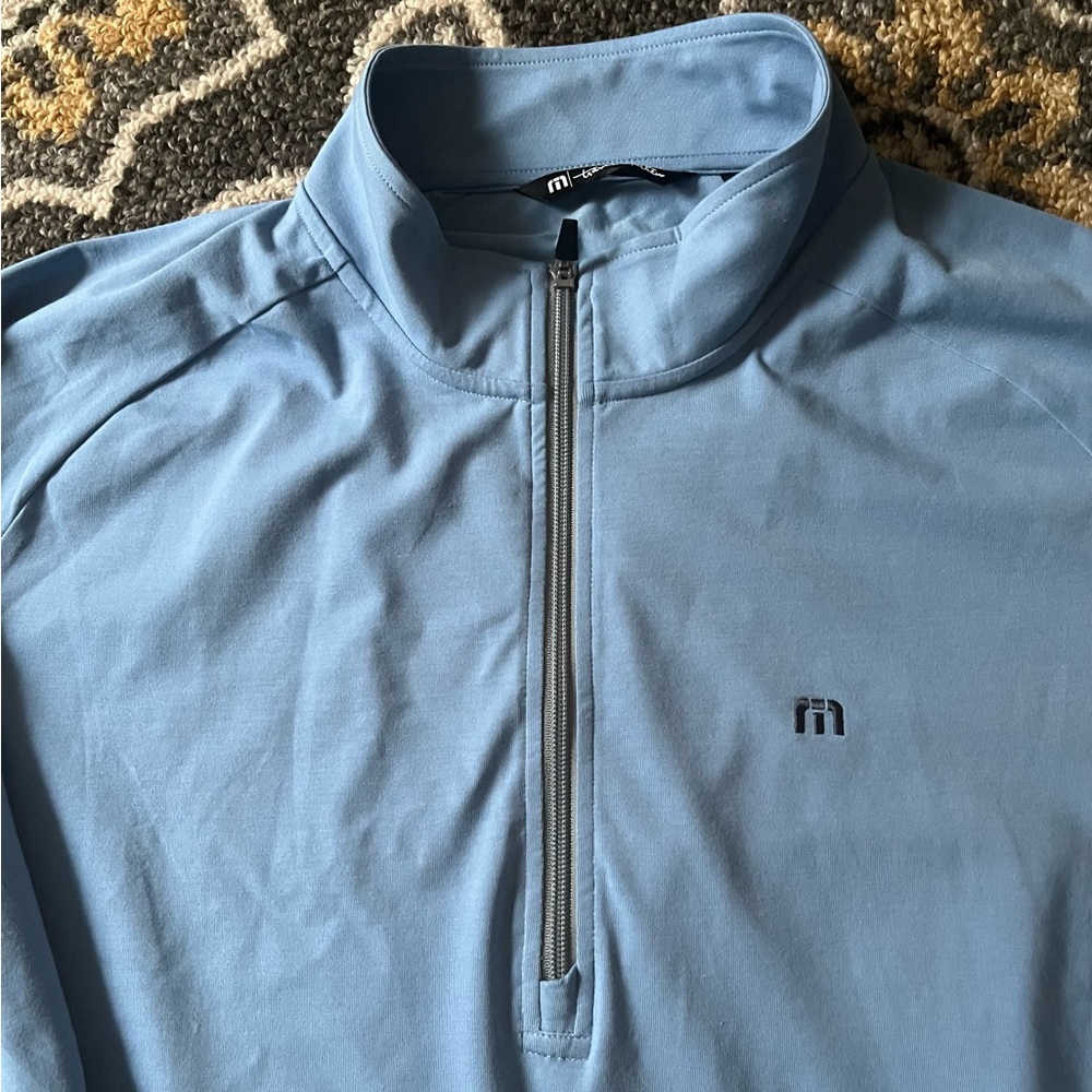 Men’s Travis Mathew 1/4 zip pull over. New without tags.